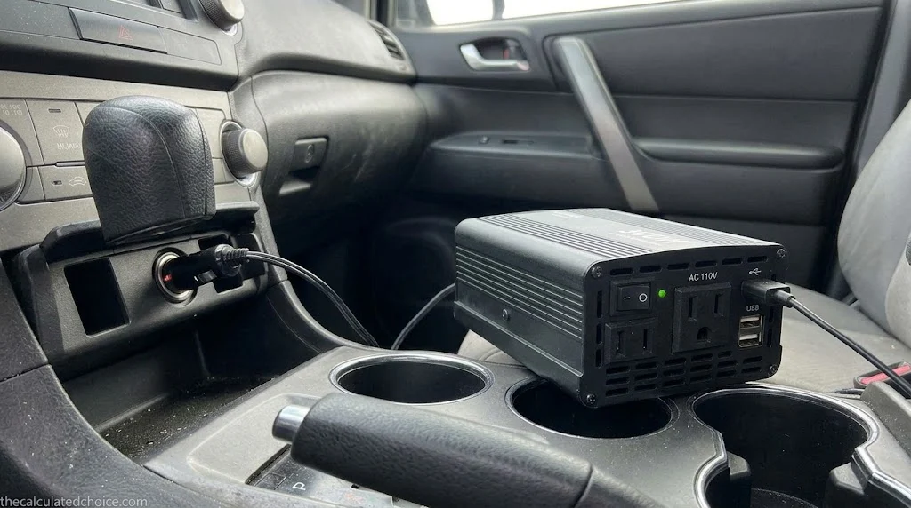 What can a 300W power inverter run: car power inverter sitting on the center console with its cord running to the 12V socket